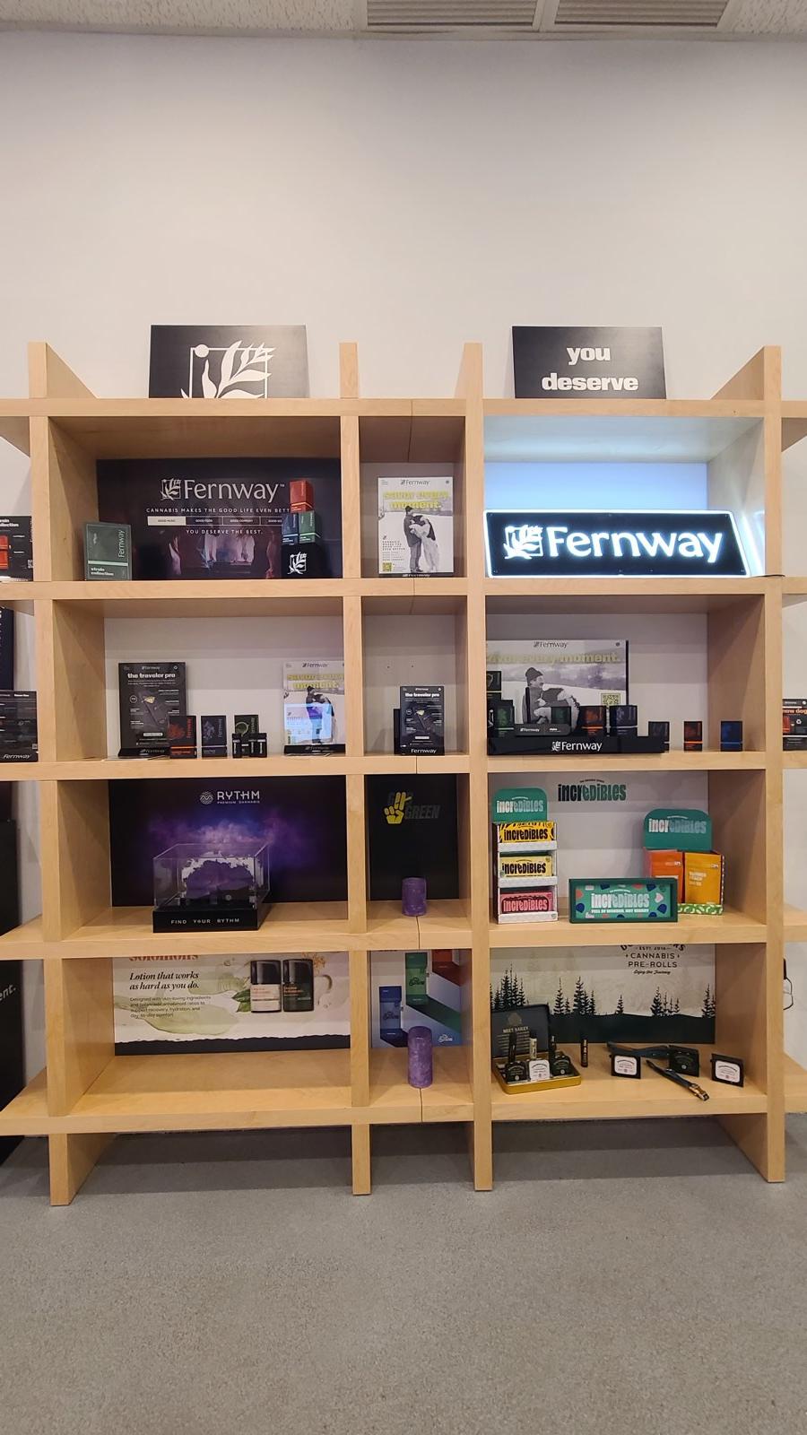 Wall of cannabis edibles, flower, and accessories on the shelves at ANJA
